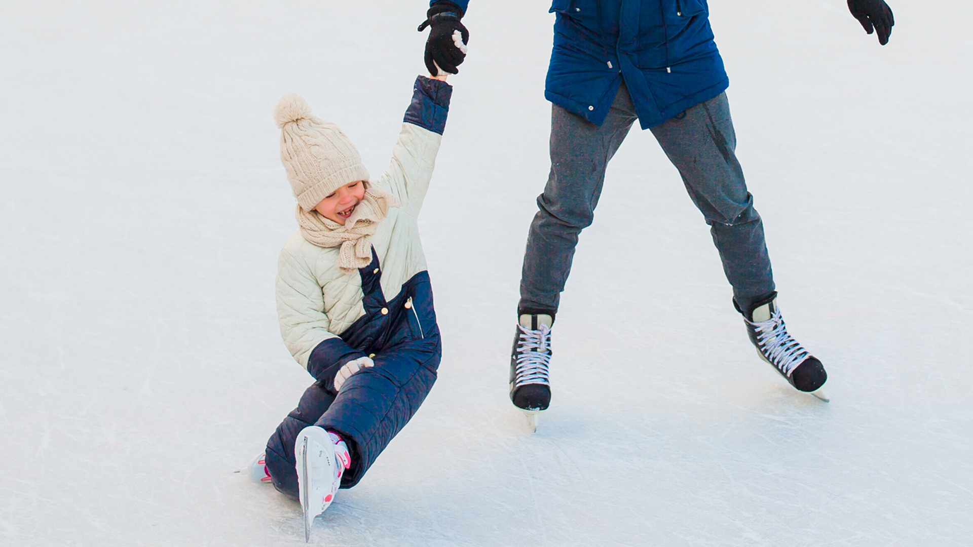 Muskoka family skate shows girl and father enjoying winter sports outside.
