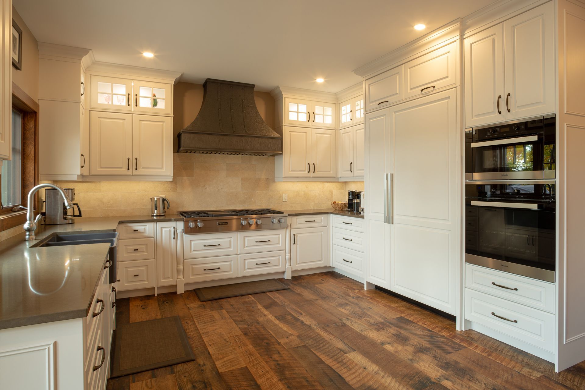 This beauty has all the latest conveniences including a  hidden double door fridge and custom metal range hood.