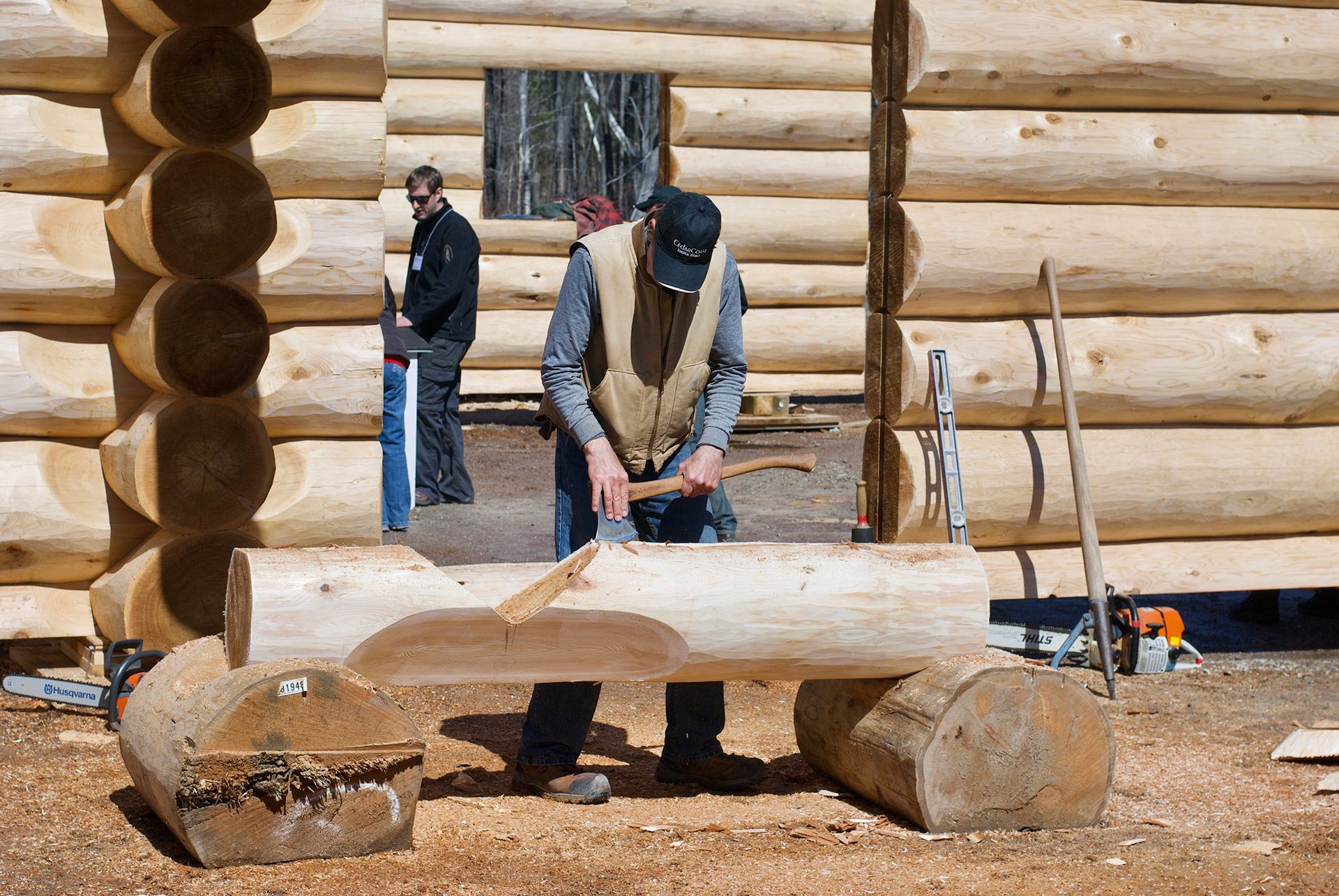 Log crafstman demonstrates detailing.