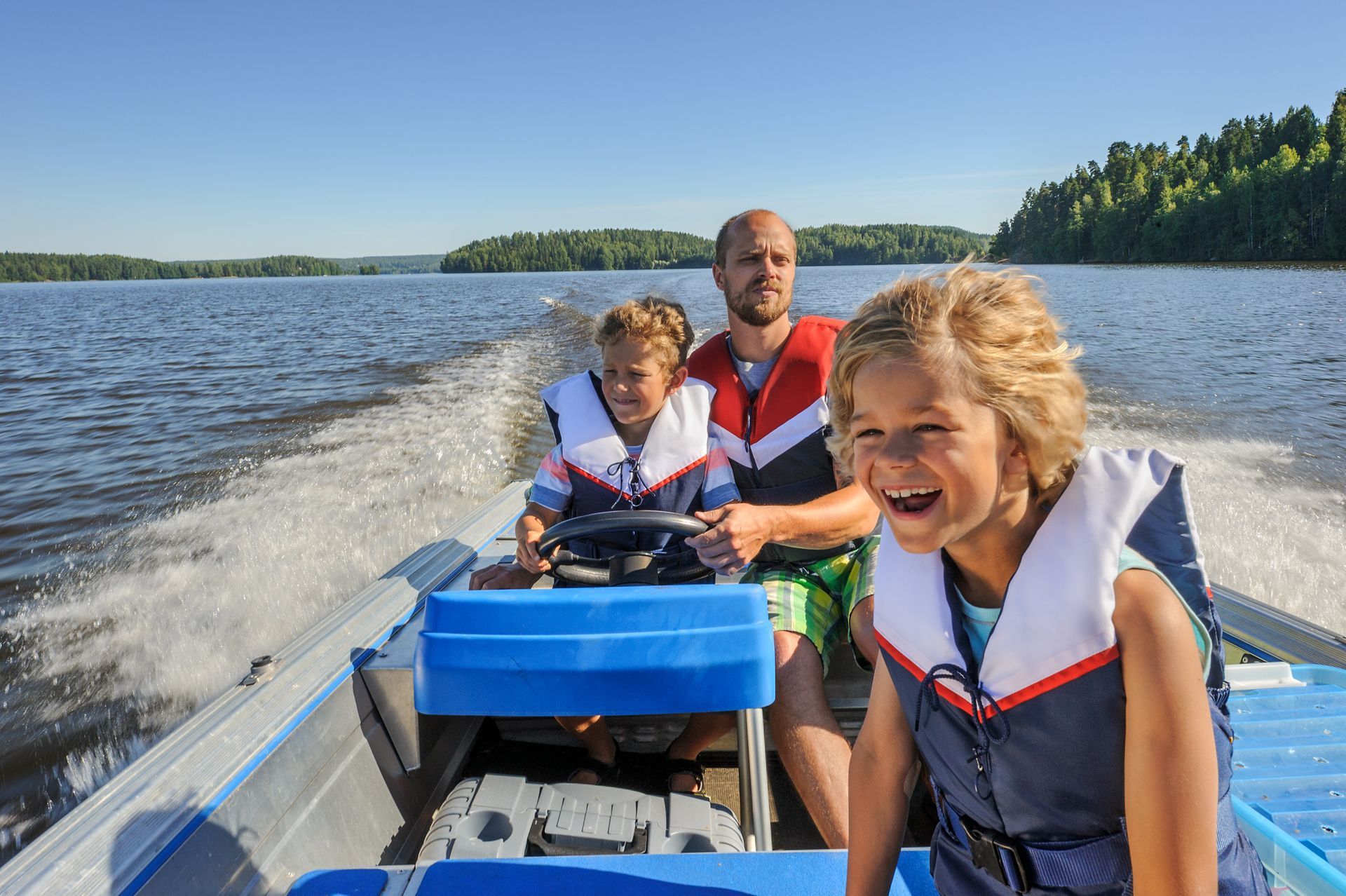 Family enjoying a boat ride in Muskoka.