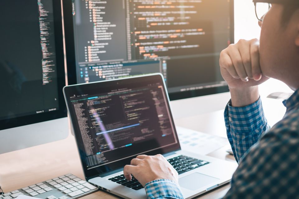 a men coding over the laptop