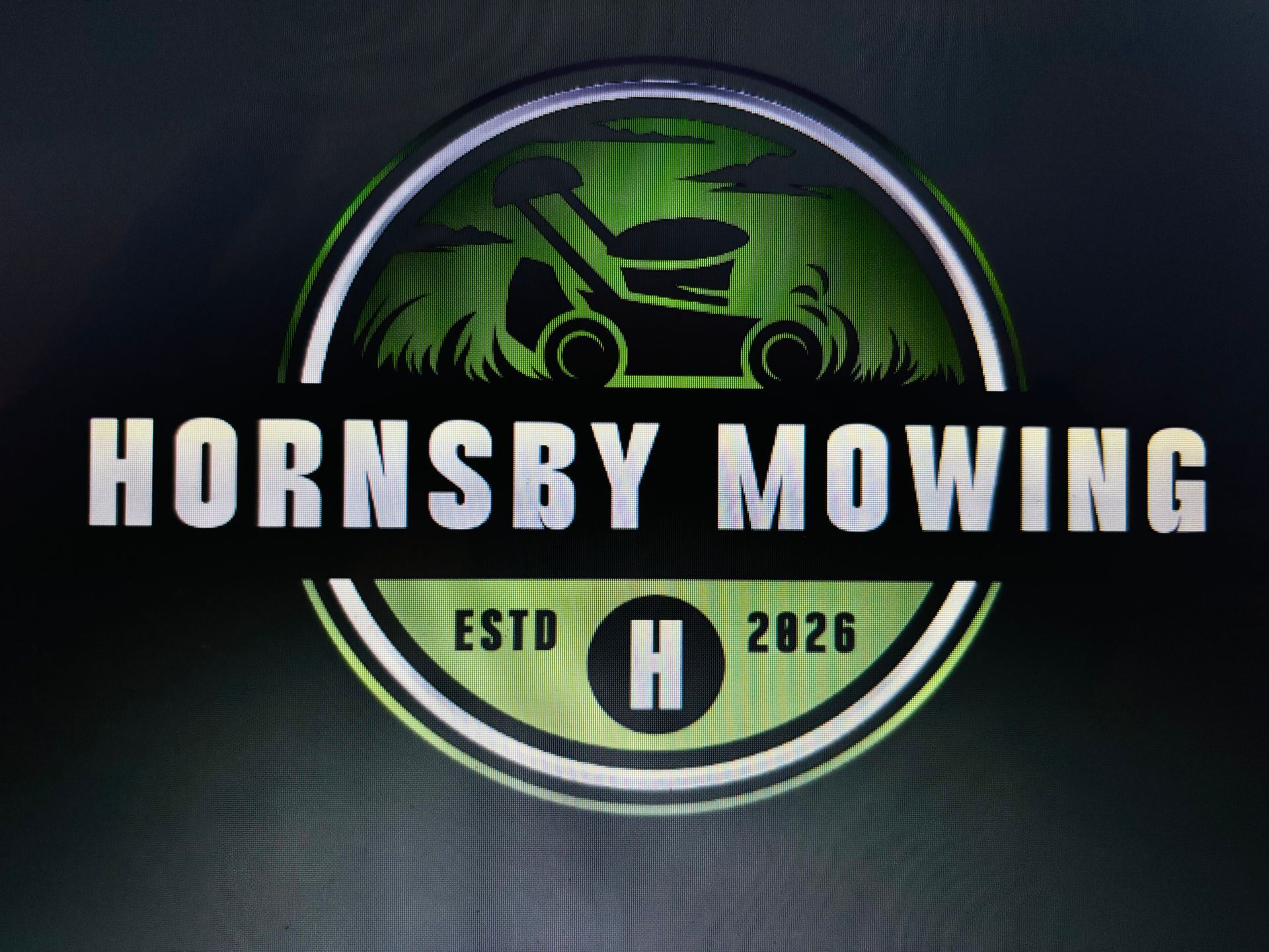 Hornsby Mowing logo with green lawn mower in a circular badge on a dark background