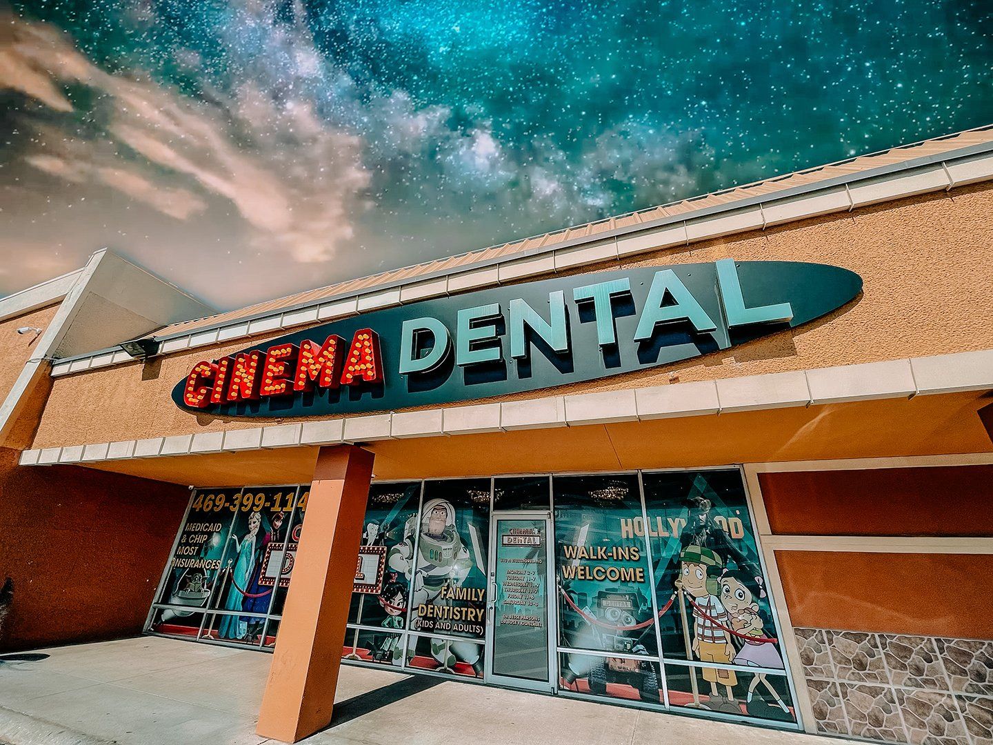 Cinema Dental storefront with movie posters, under a starry sky.