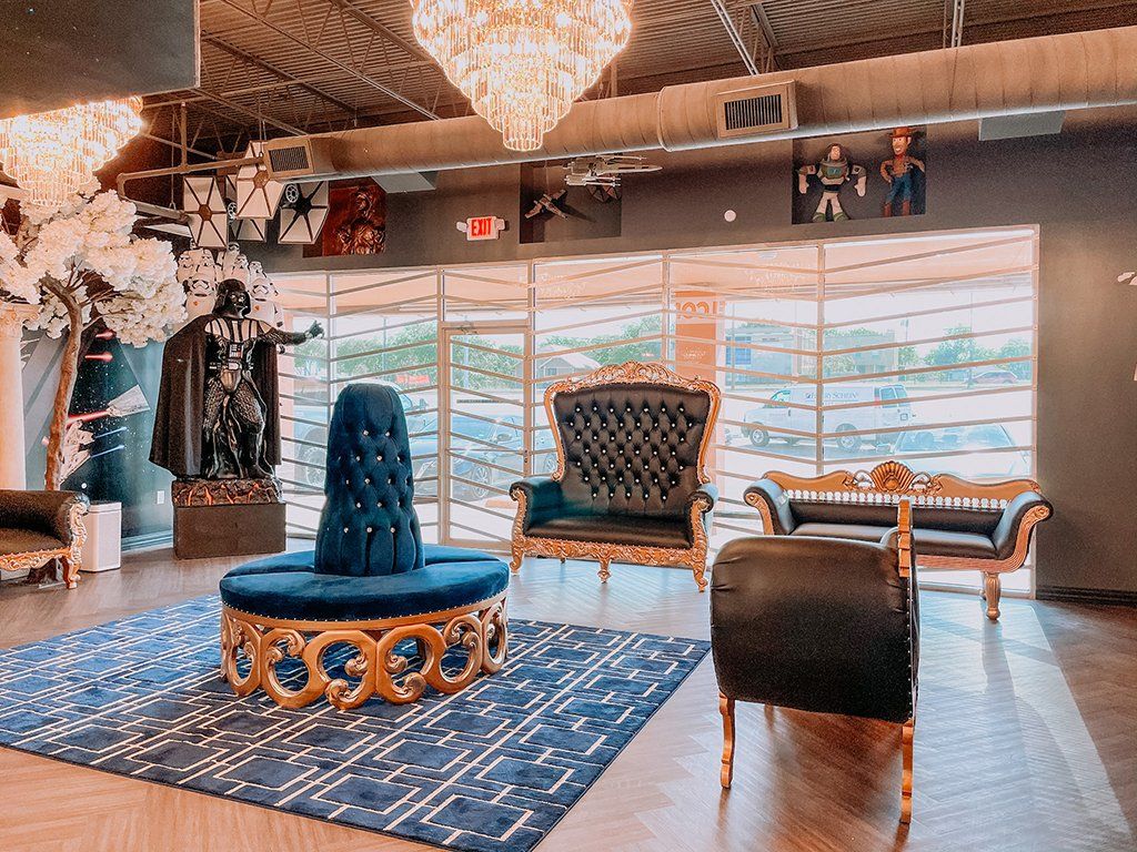Elegant lounge with gold accents, velvet seating, and Star Wars decor.