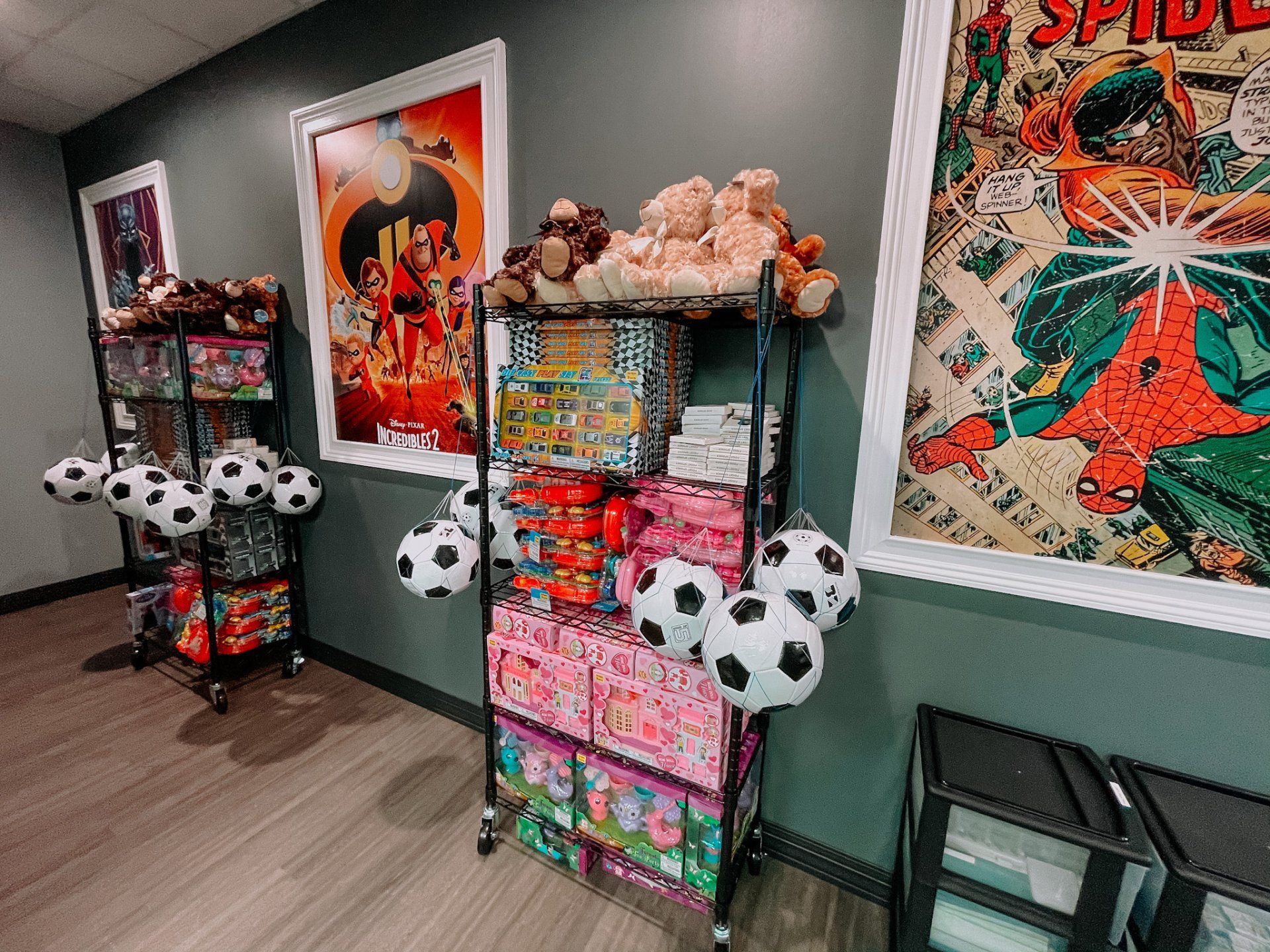Shelves with toys, soccer balls, and stuffed animals; posters on the wall.