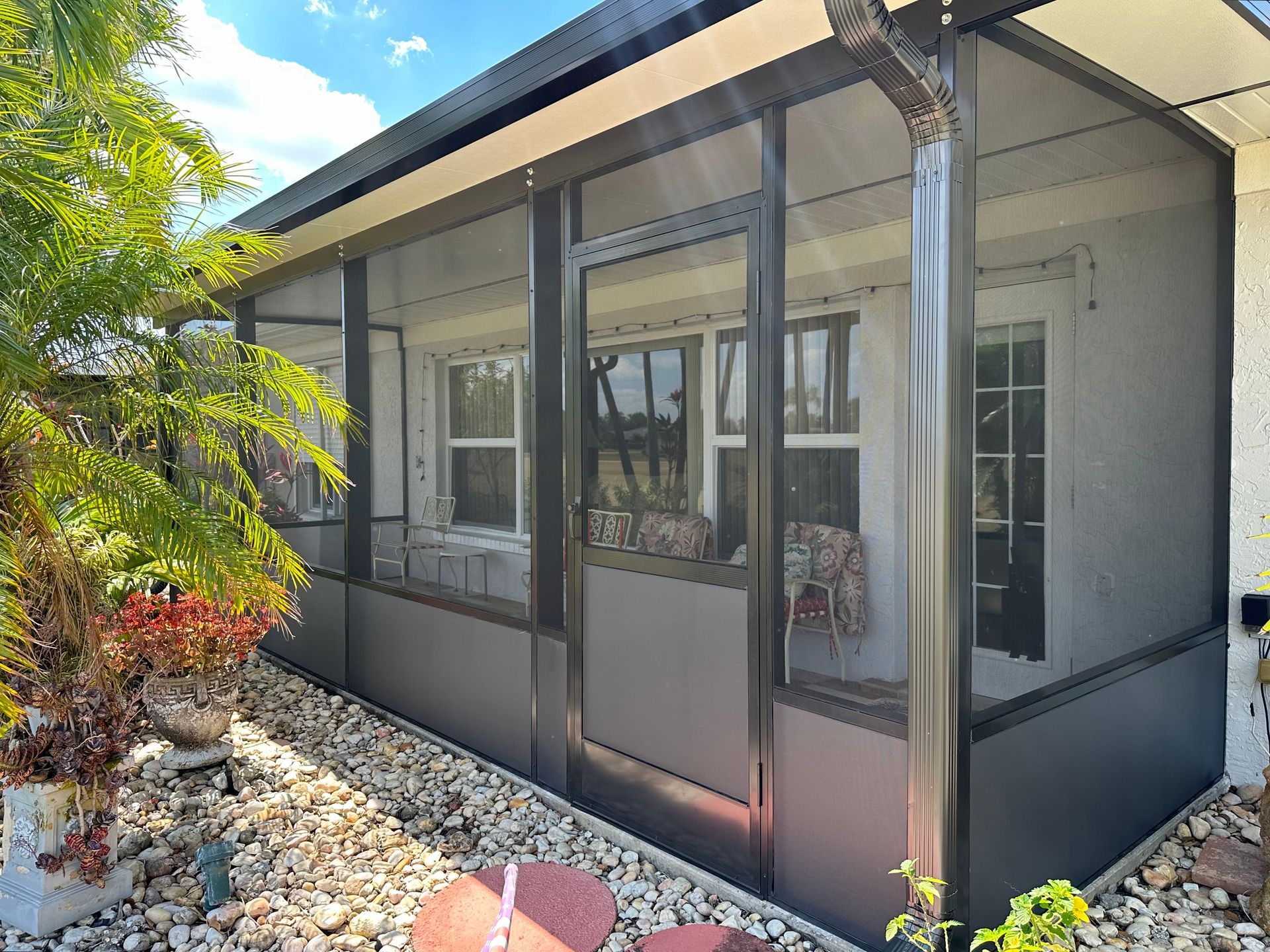 There is a screened in porch with a lot of windows.