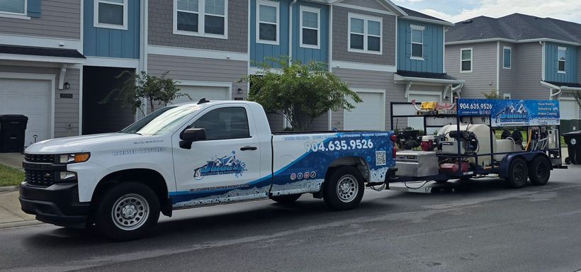 A truck and trailer are parked on the side of the road.