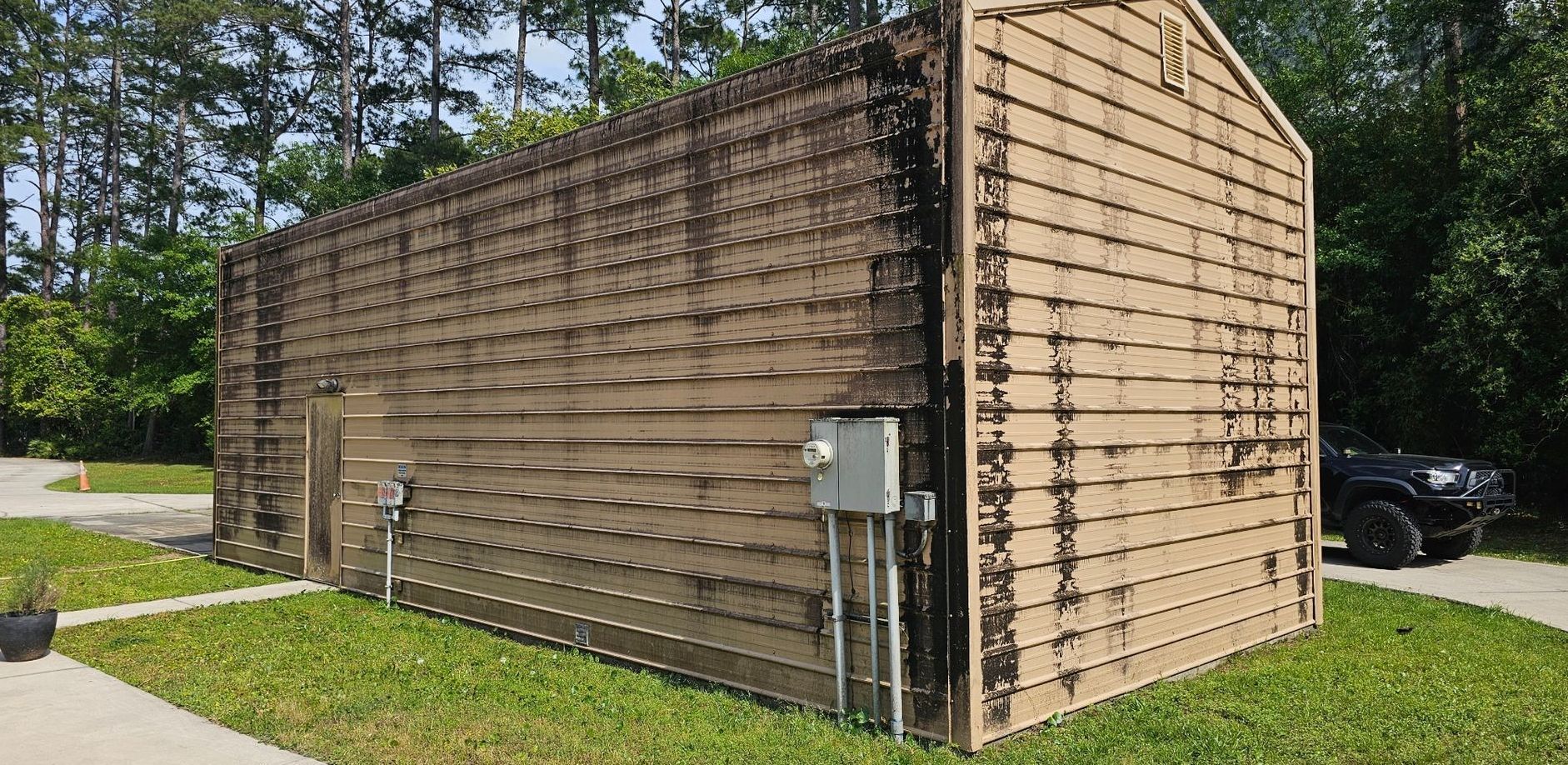 A close up of a wall with a brown stain on it.