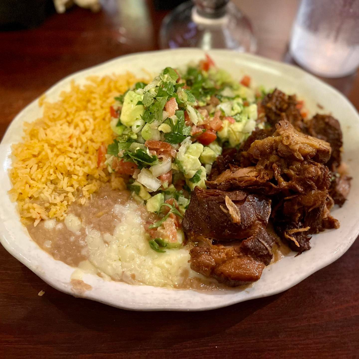 carnitas with refried beans and rice