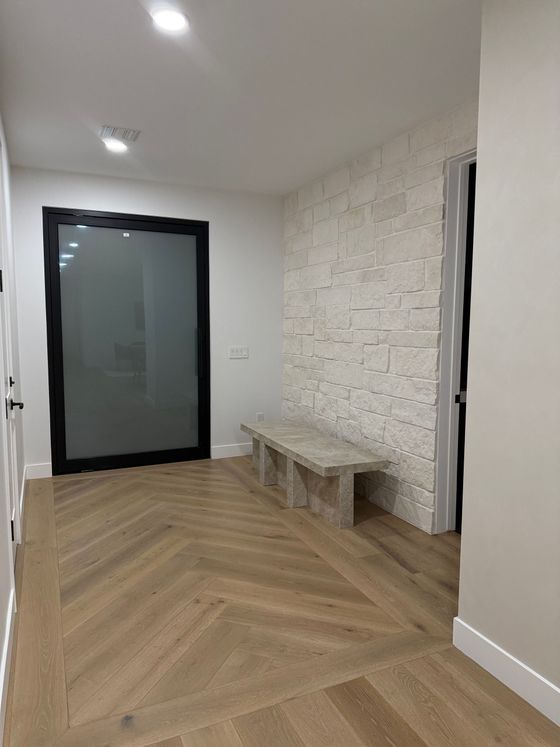 A bathroom with two sinks and a walk in shower.