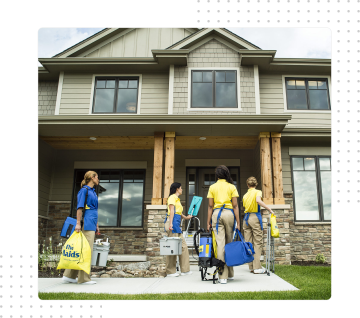 People carrying bags and luggage to the front porch of a suburban house