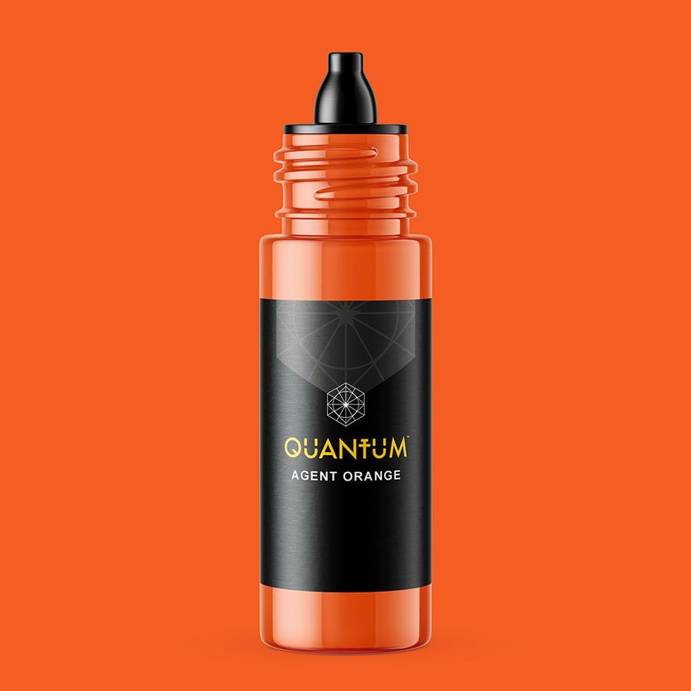 A small bottle of Quantum Agent Orange tattoo ink with a black cap and label, set against a solid orange background.