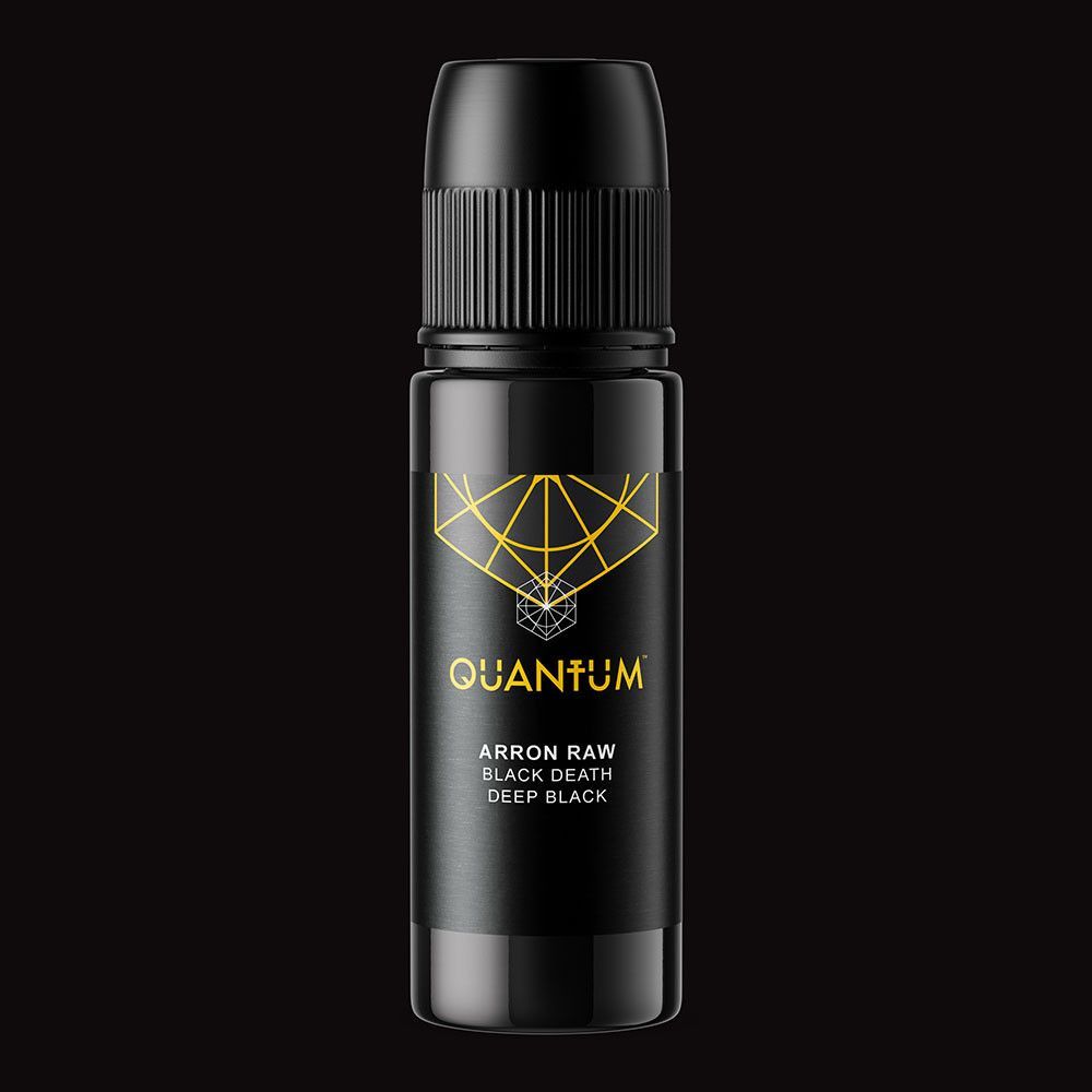 A black bottle of Quantum tattoo ink with gold branding, centered on a plain black background.