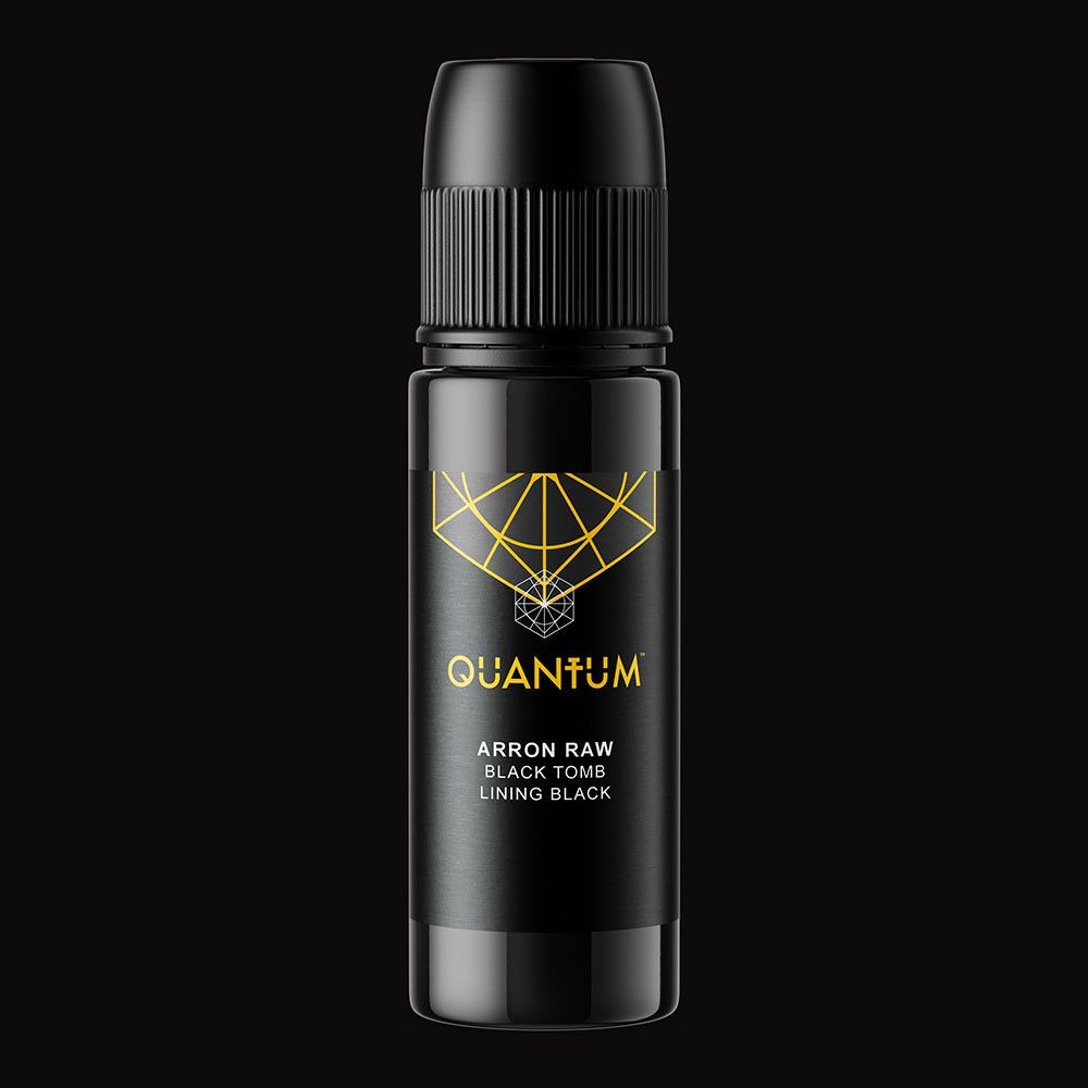 A black bottle of Quantum tattoo ink with gold branding, centered on a black background.