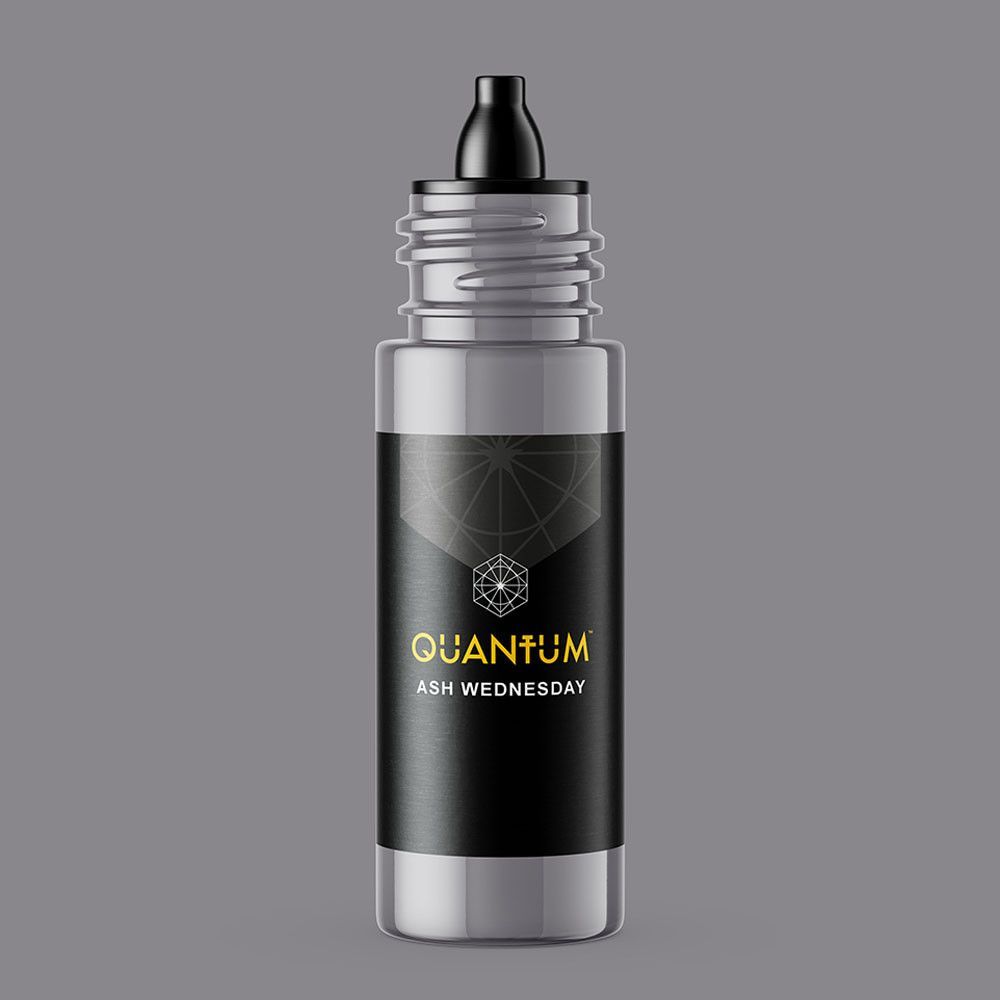 A cylindrical bottle with a black cap and label, featuring the gold text