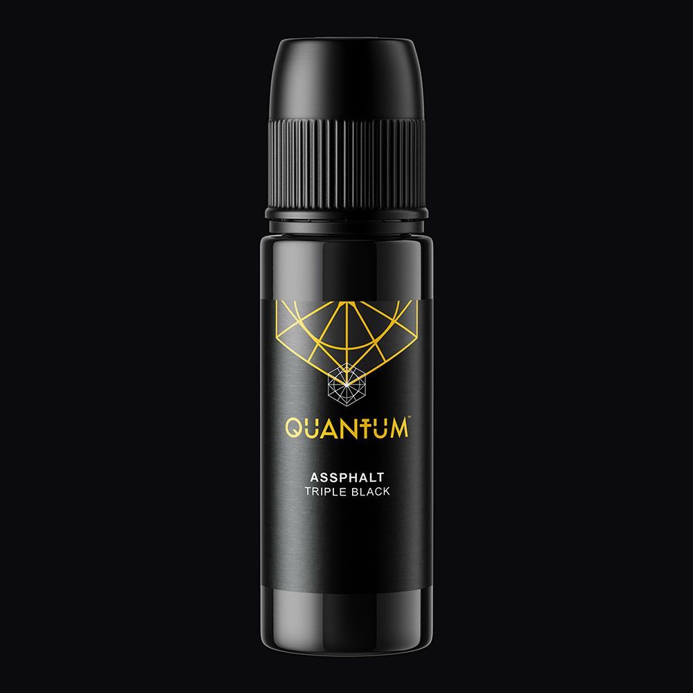 A small bottle of Quantum brand tattoo ink with a black cap, gold logo, and white label on a white background.