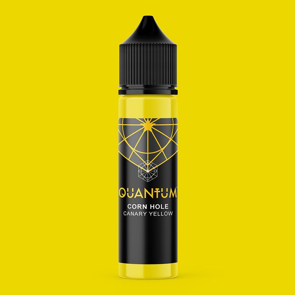 A black bottle of Quantum tattoo ink with a geometric logo and gold text on a dark background.