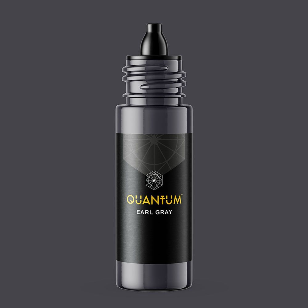 A bottle of Quantum Earl Gray liquid on a dark gray background.