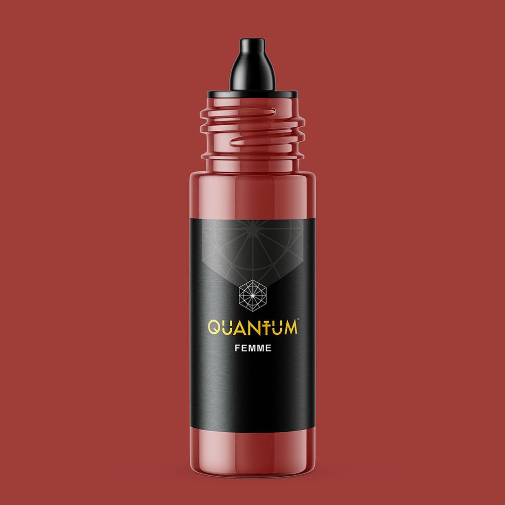 A small bottle of Quantum Femme pigment with a black cap and label, set against a matching terracotta background.