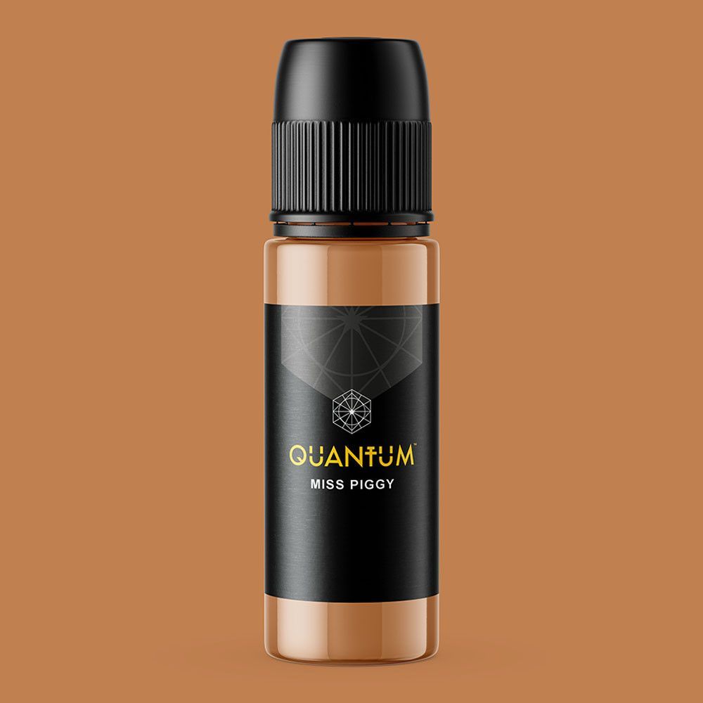 A bottle of light-brown Quantum permanent makeup pigment with a black label and a dropper-style cap.