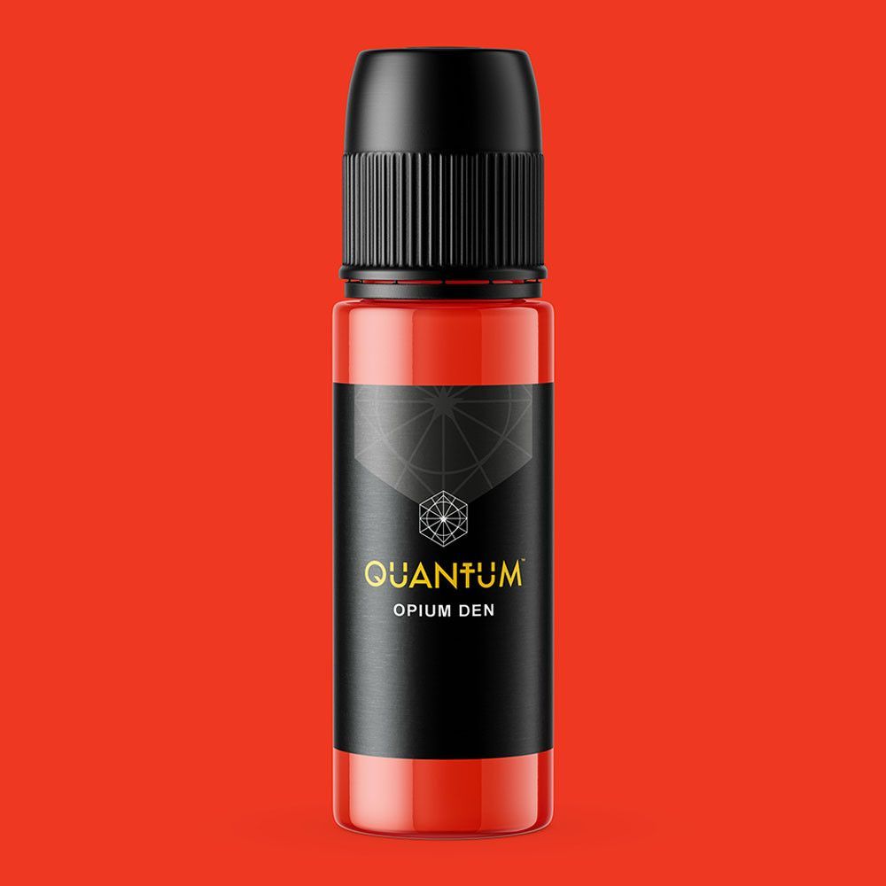 A squeeze bottle of orange Quantum tattoo ink labeled