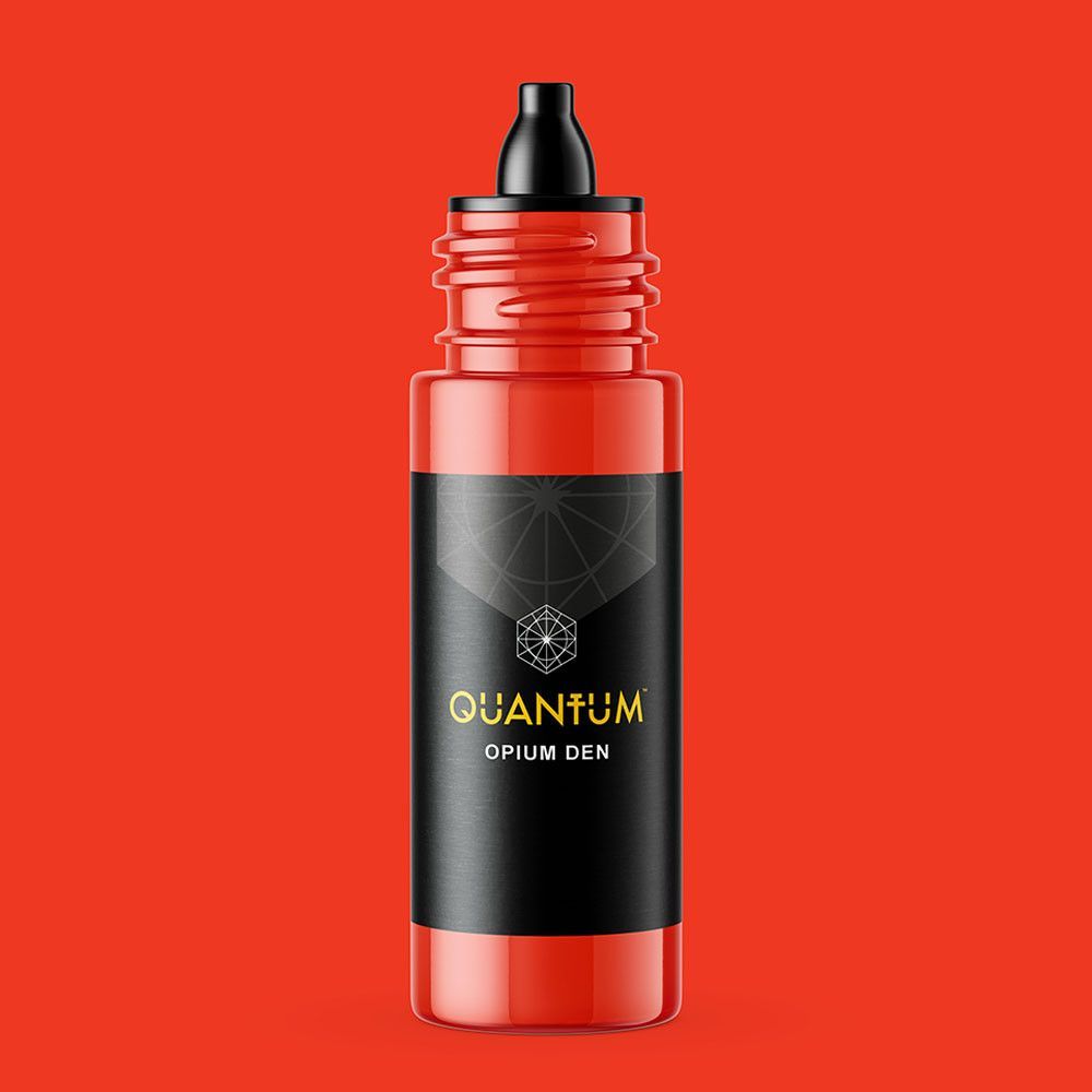 A squeeze bottle of orange Quantum tattoo ink labeled