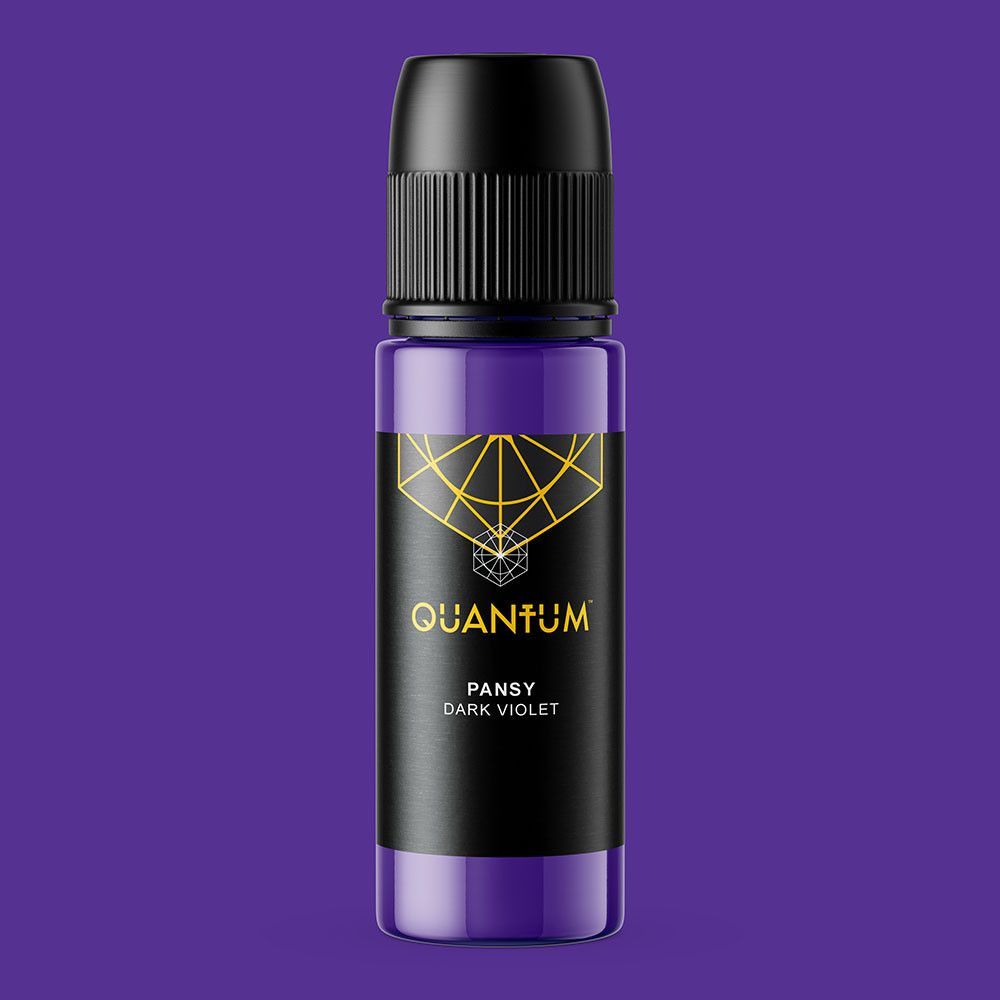 A small, violet-colored bottle of Quantum tattoo ink with a black label featuring a gold geometric design.