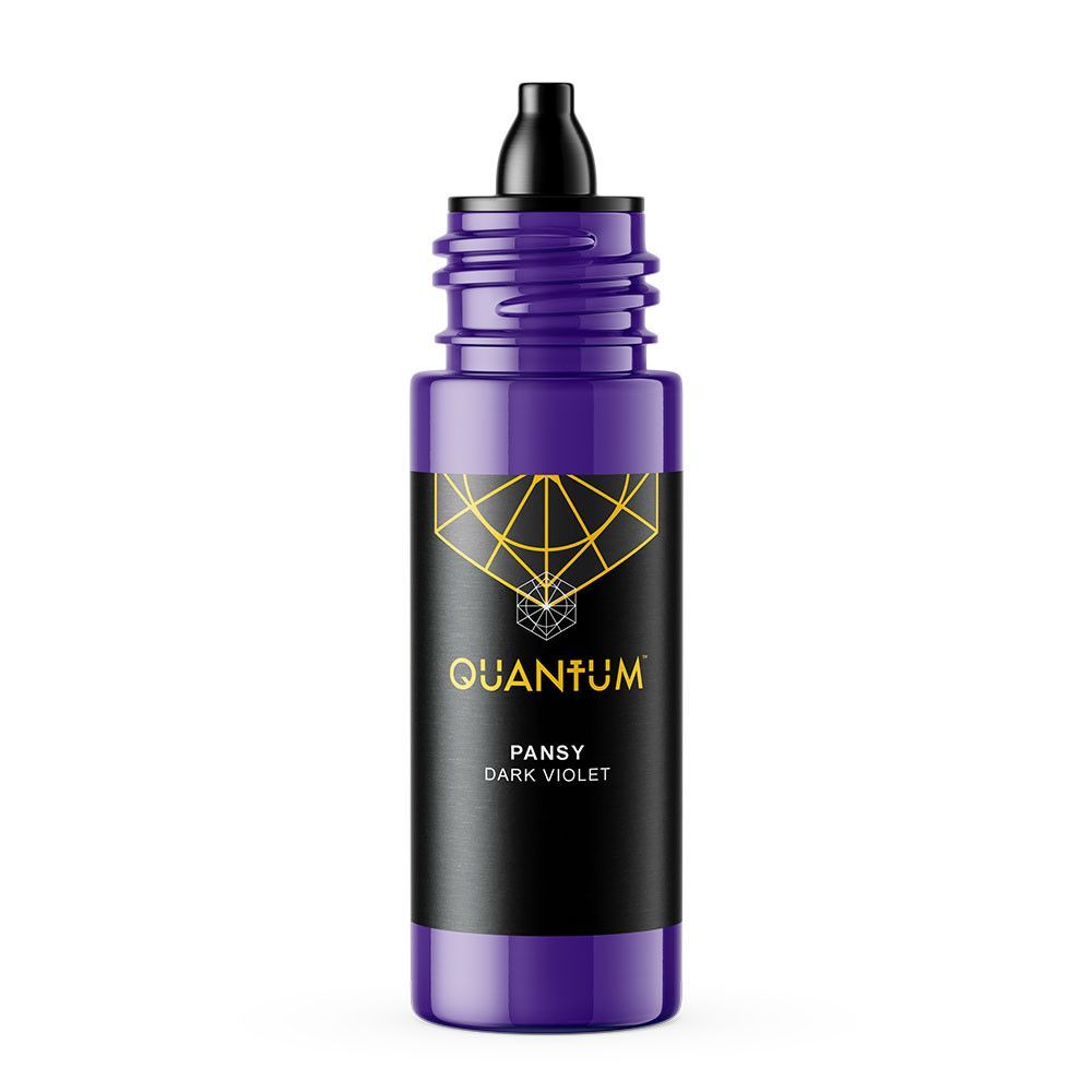 A small, violet-colored bottle of Quantum tattoo ink with a black label featuring a gold geometric design.