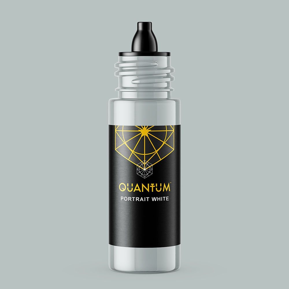 A bottle of Quantum Tattoo Ink, labeled Portrait White, with a black label featuring a gold geometric design.