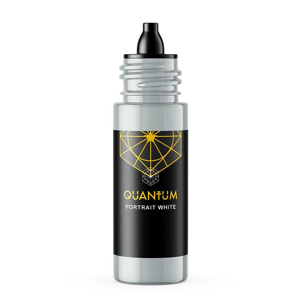 A bottle of Quantum Tattoo Ink, labeled Portrait White, with a black label featuring a gold geometric design.