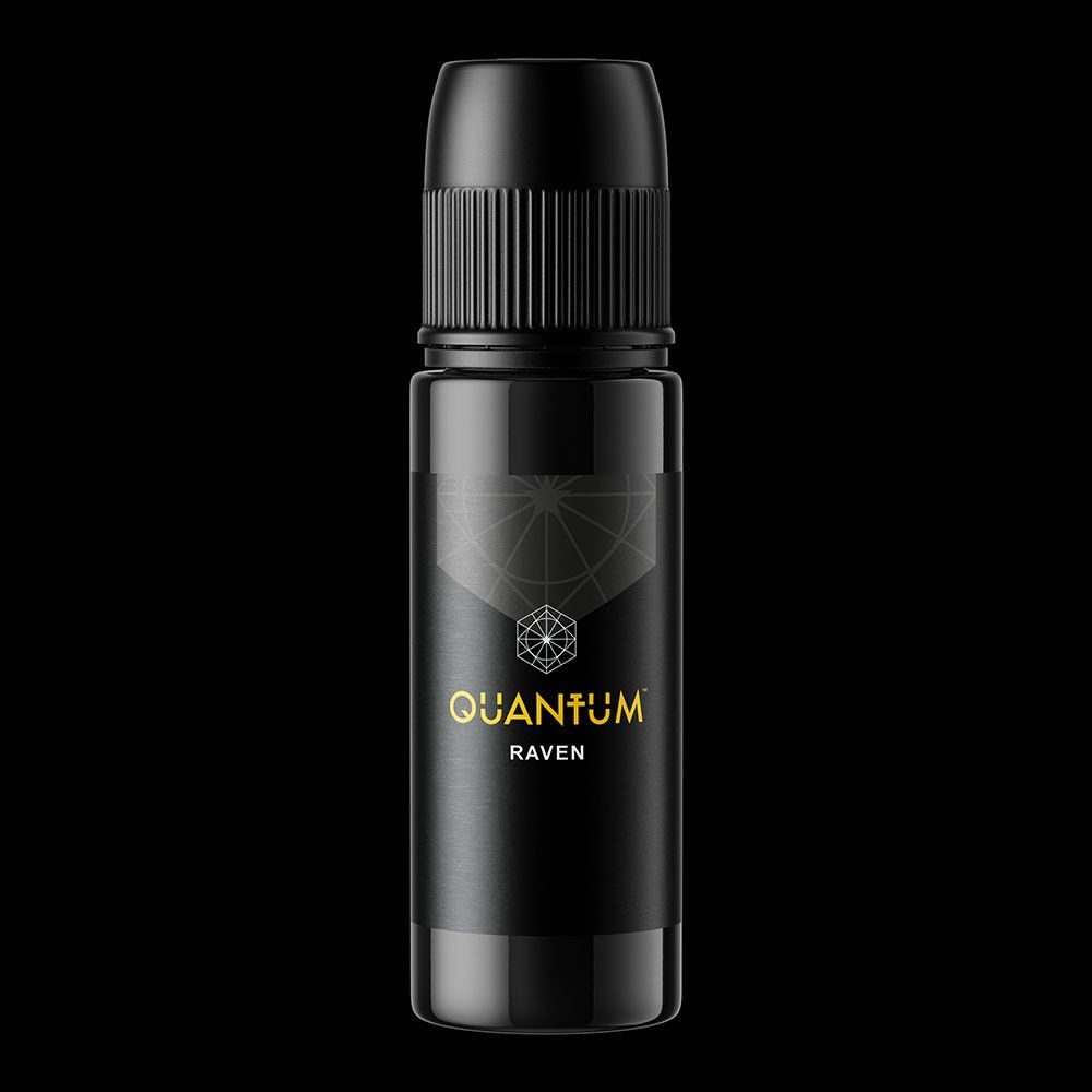 A black bottle of Quantum Raven tattoo ink with gold lettering against a black background.