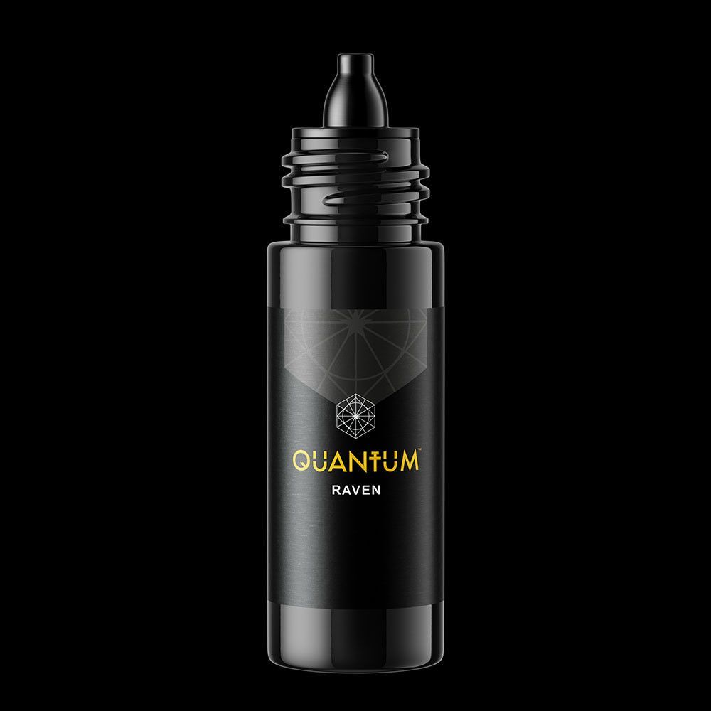 A black bottle of Quantum Raven tattoo ink with gold lettering against a black background.