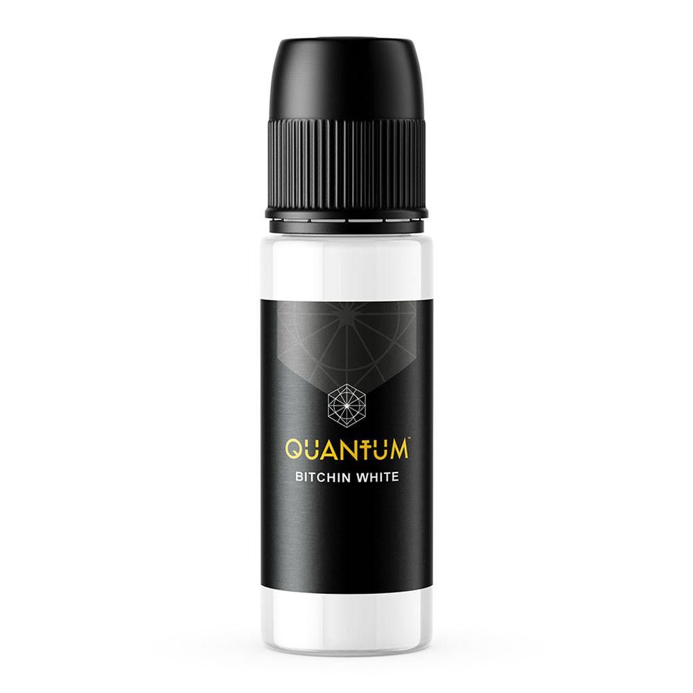 A white bottle of Quantum tattoo ink with a black label featuring a geometric logo and the text