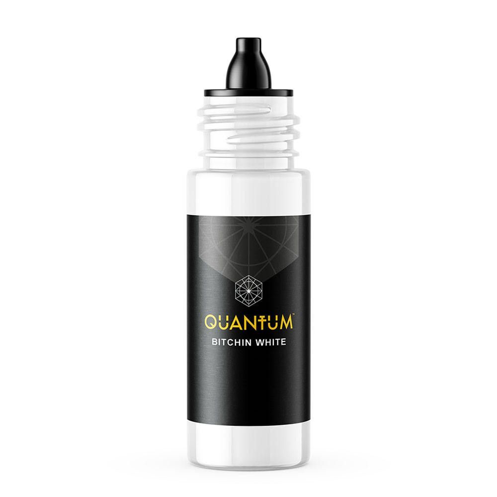 A white bottle of Quantum tattoo ink with a black label featuring a geometric logo and the text