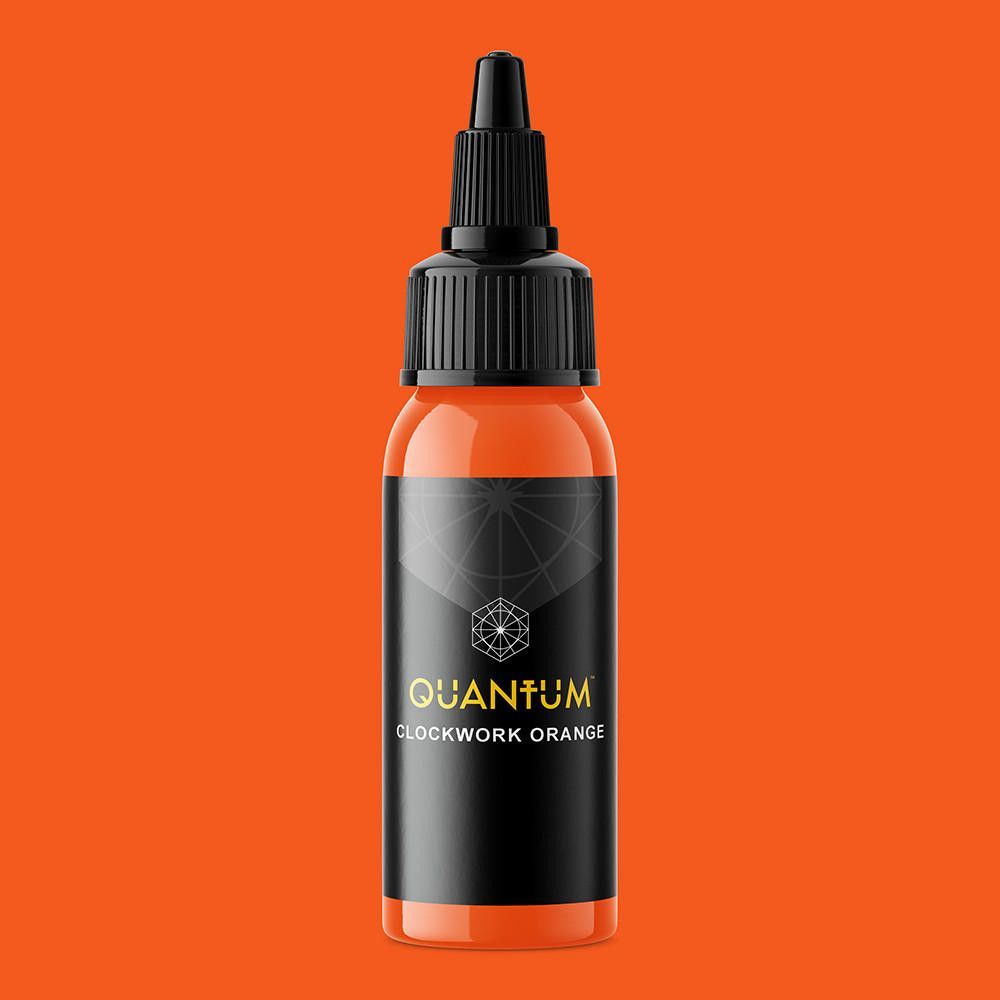 A bottle of bright orange tattoo ink labeled