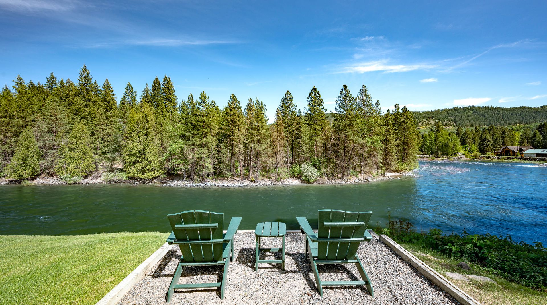 Green chairs over looking the river at the All Seasons River Inn in Leavenworth, WA