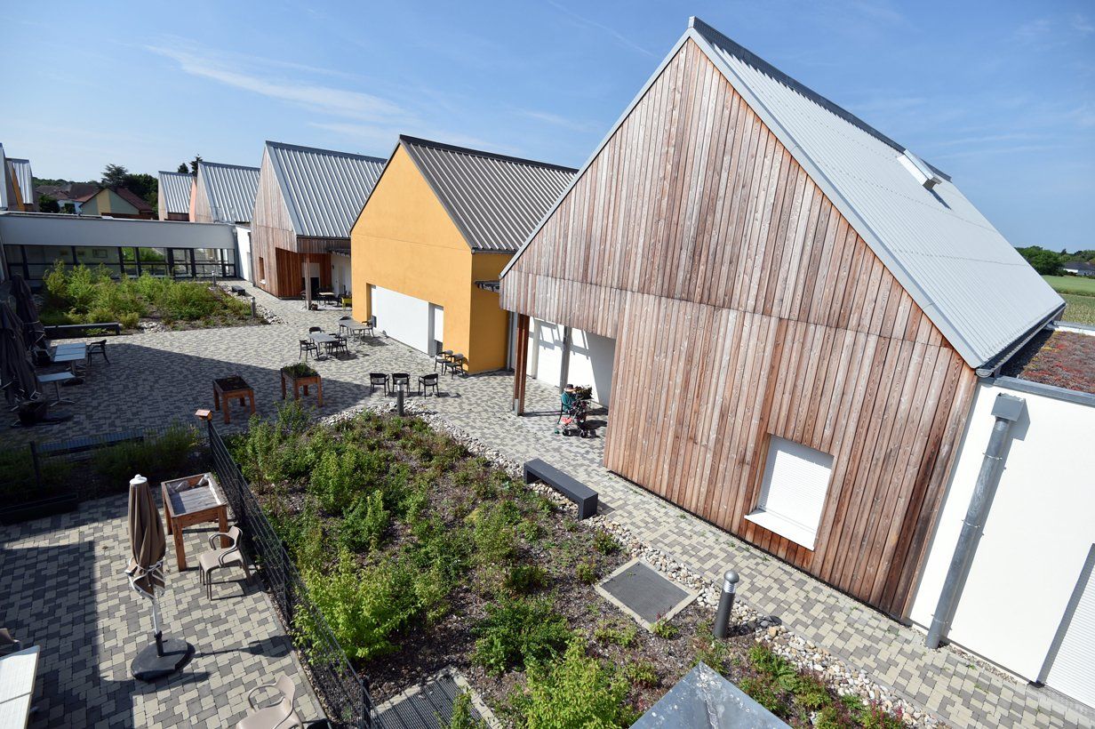 Un groupe de maisons avec un toit qui ressemble à une grange.