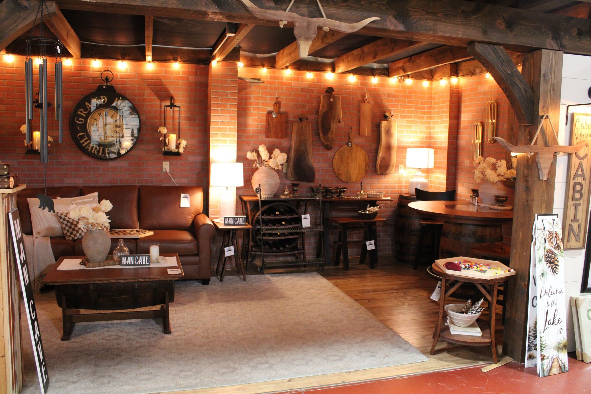 A rustic furniture store interior with wooden beds, chairs, dressers, and decorative items.