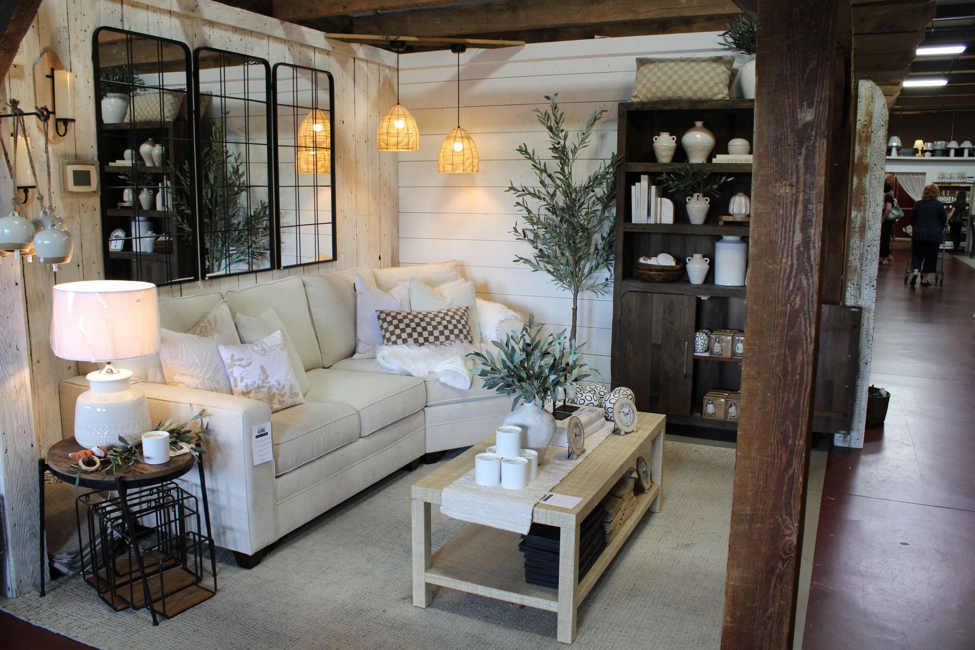 Living room display with blue sofas, coffee table, and rustic decor.