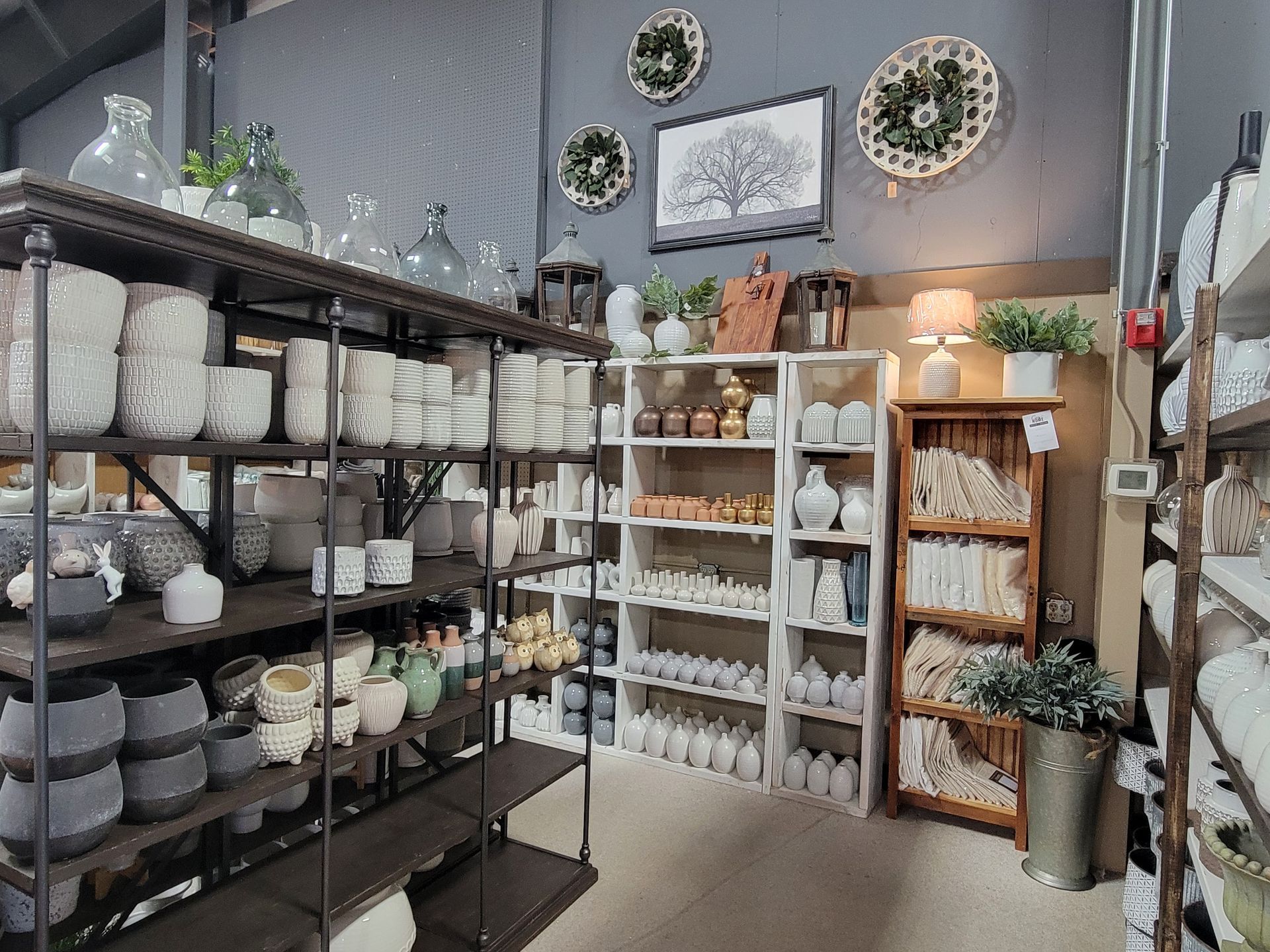 A variety of ceramic vases, pottery, and home decor items in a store. A variety of ceramic vases, pottery, and home decor items in a store.