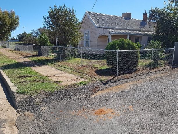 A House With A Chain Wire Fence And A Car Parked In Front — Anne & Ron Johnson Fencing in Werris Creek, NSW