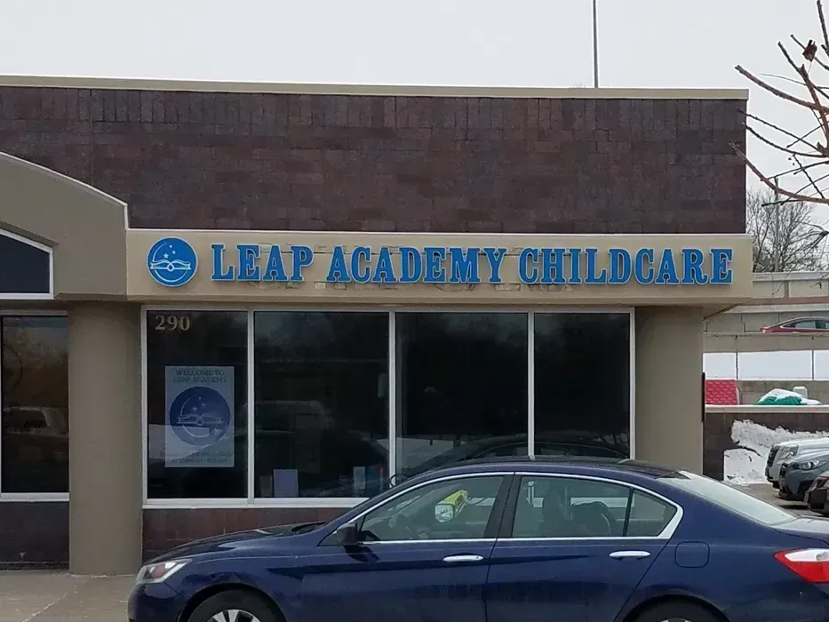 Front of Leap Academy Childcare building with a blue car parked outside