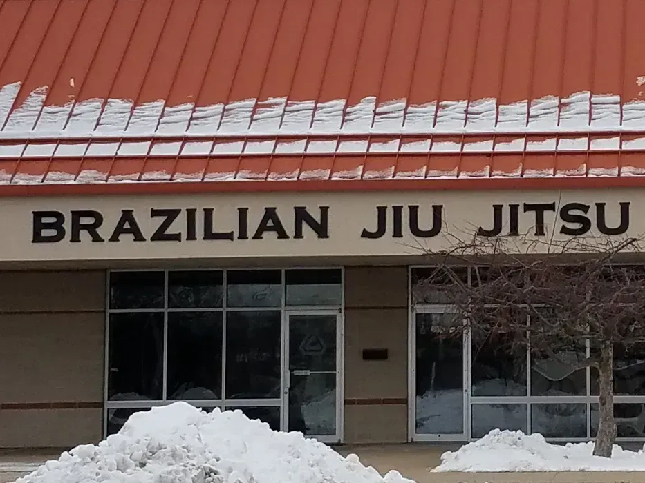 Brazilian Jiu Jitsu gym storefront with snow piled outside under a red roof