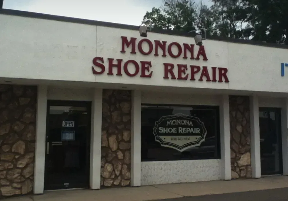 Monona Shoe Repair storefront with stone facade and red sign above the entrance
