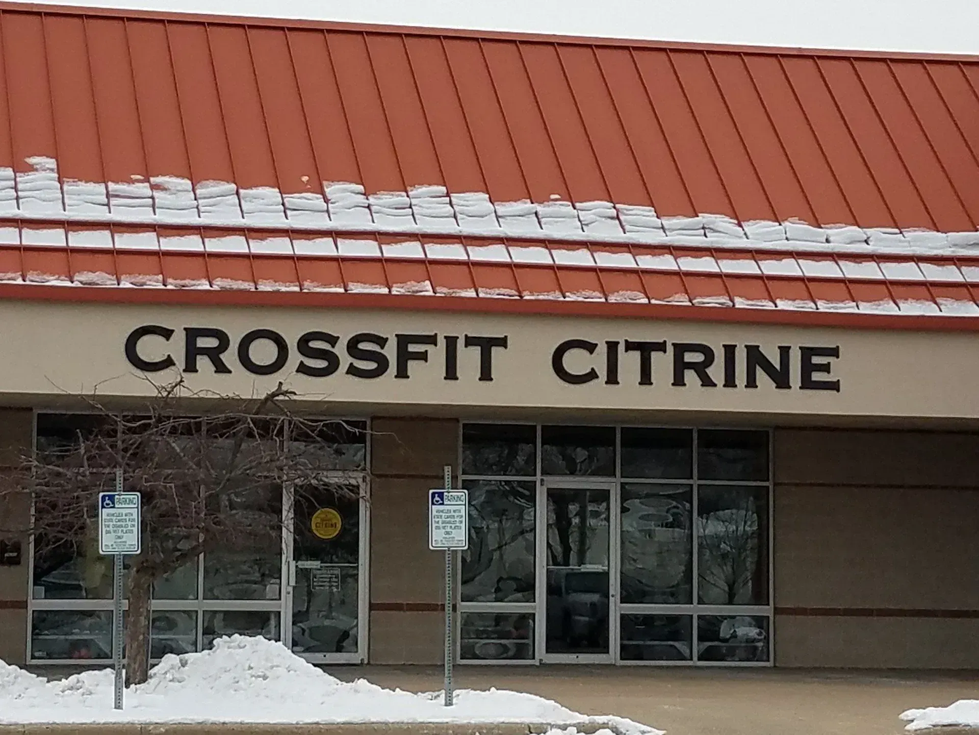 Storefront of CrossFit Citrine with a red roof and snow outside