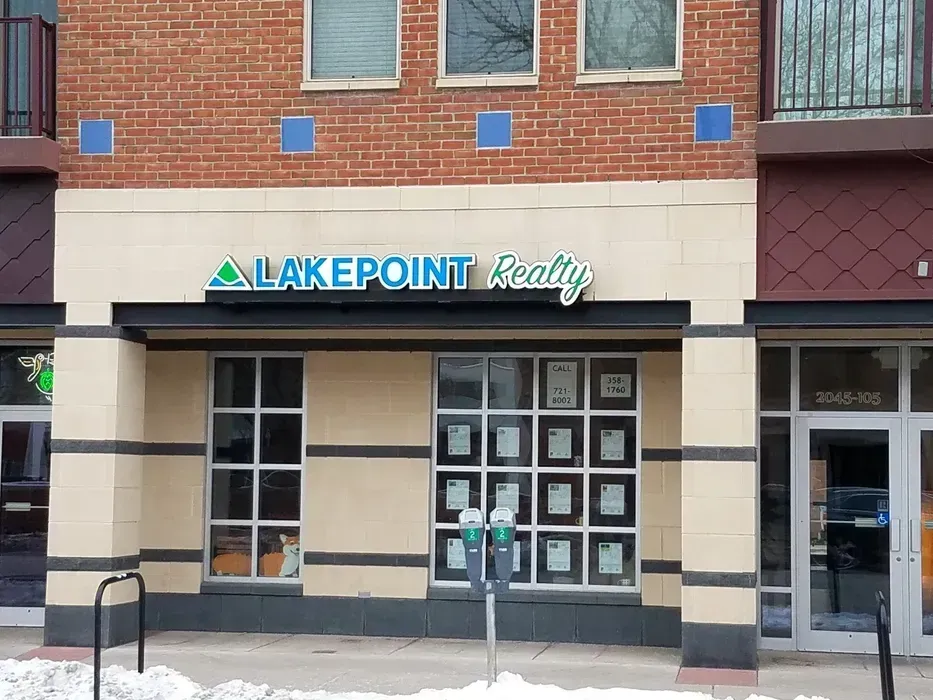 Storefront for Lakepoint Realty with brick facade and glass doors.