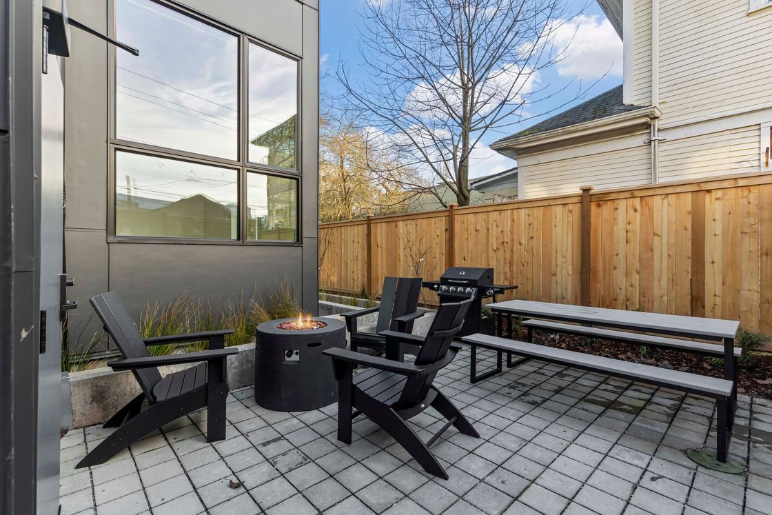 Outdoor amenity area with picnic table, BBQ, and propane fireplace