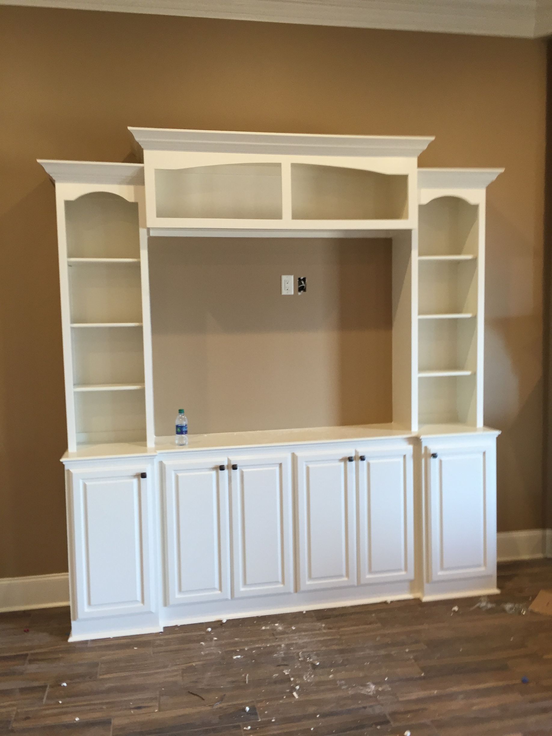 A large white entertainment center in a living room