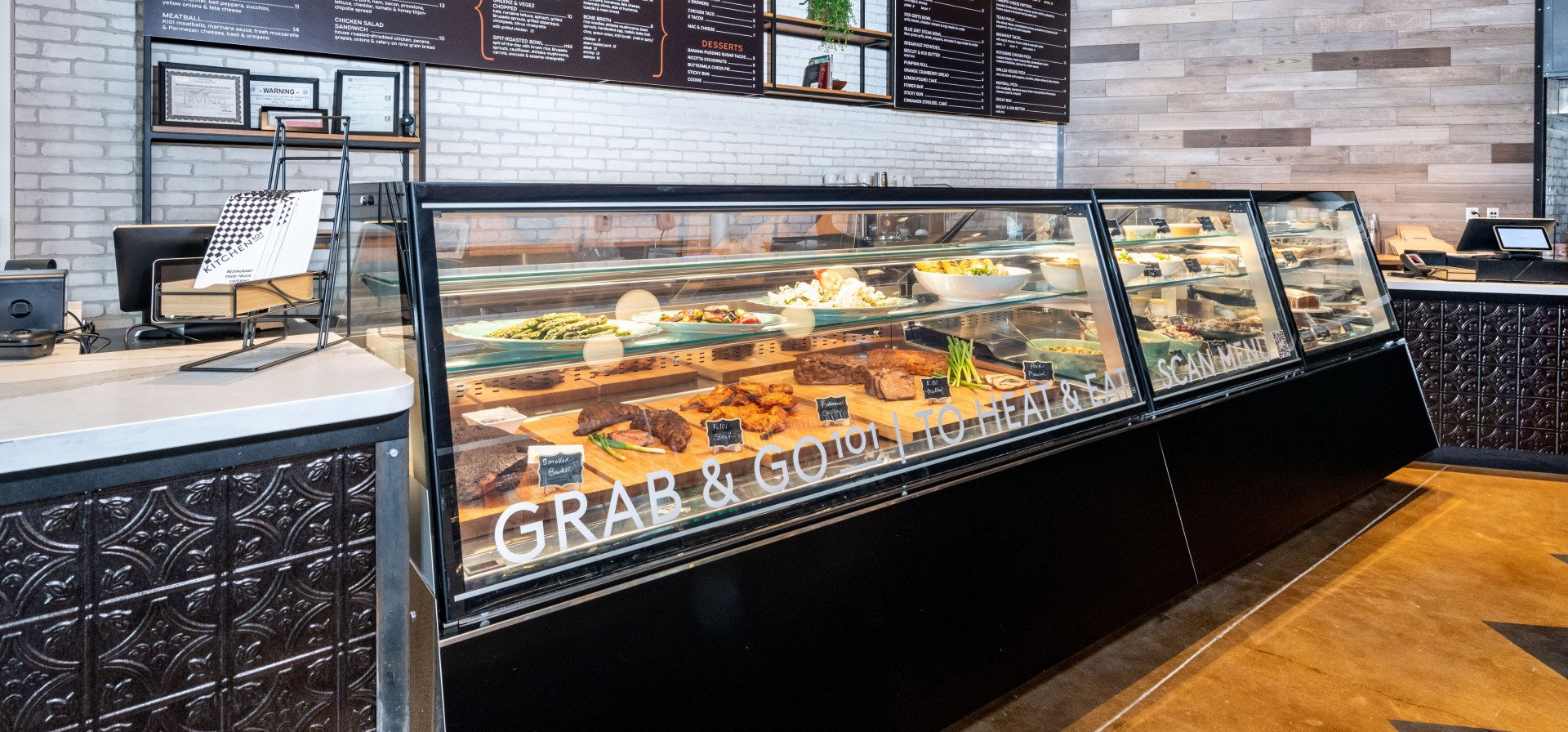 A bakery with a large display case filled with food.