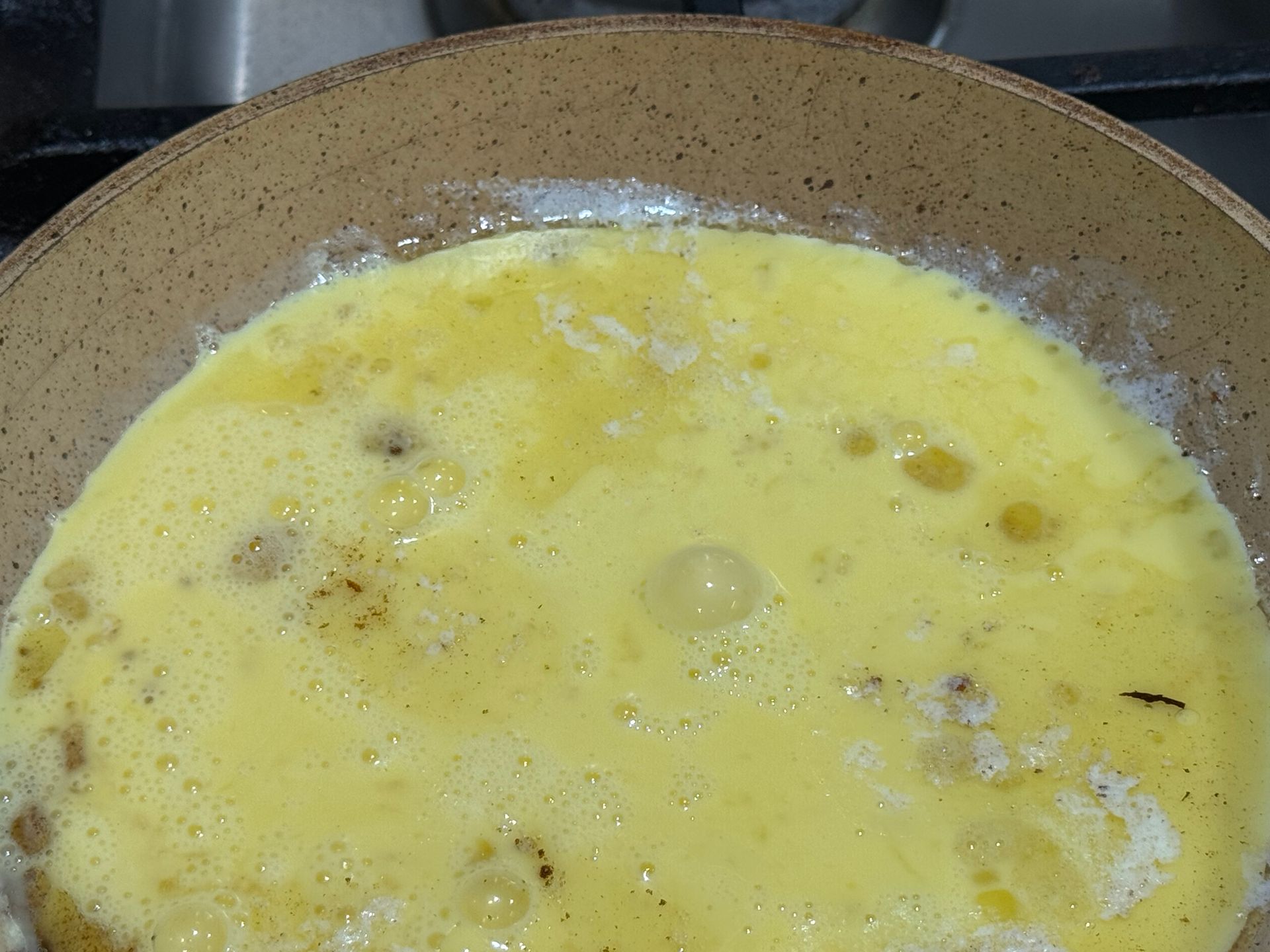 A tortilla with meat rice and cheese on it